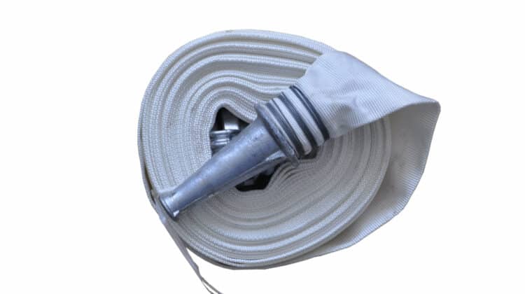 White rolled up fire extinguishing hose with coupling and nozzle