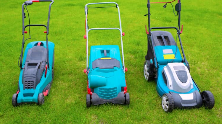 Lawn mowers standing in the backyard in a sunny summer day a close-up