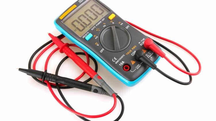 Isolated digital multimeter on white background High voltage instrument for measurement of voltage