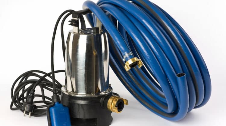 submersible pump for dirty water and a blue water hose on a white background displayed