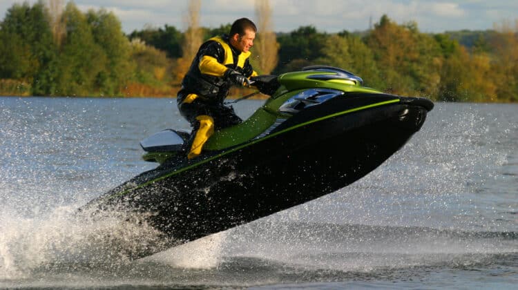 A jet ski and its rider leap clear of the water