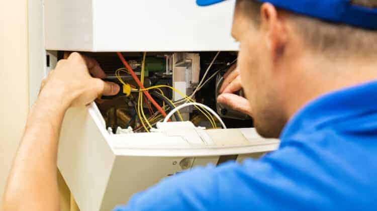 maintenance service engineer working with home gas heating boiler