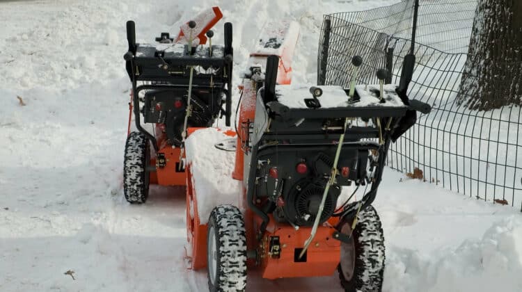 2 snow blowers in the snow