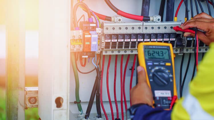 Electrician worker use multimeter to confirm current voltage and voltage Electricians use electricians work with electric wires
