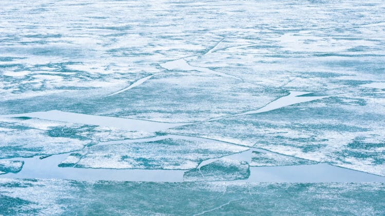 Melting ice on the frozen lake