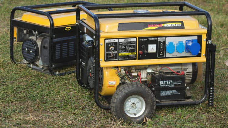 yellow petrol portable generator on wheels closeup emergency