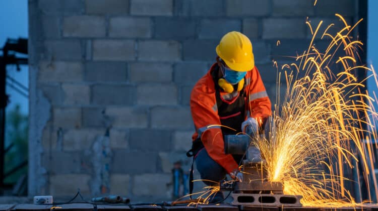 Worker with metal grinding on steel Metal grinding on steel pipe