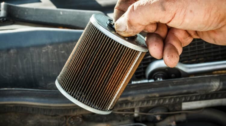 Car mechanic replace the fuel filter