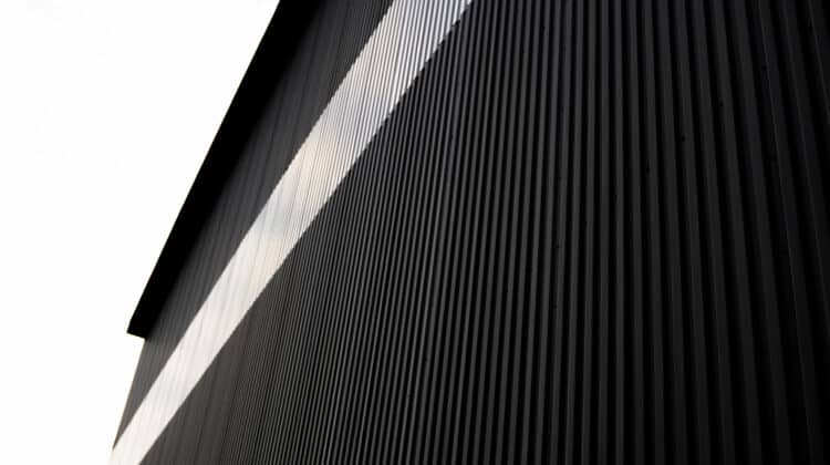 Black and white corrugated iron sheet used as a facade of a warehouse or factory