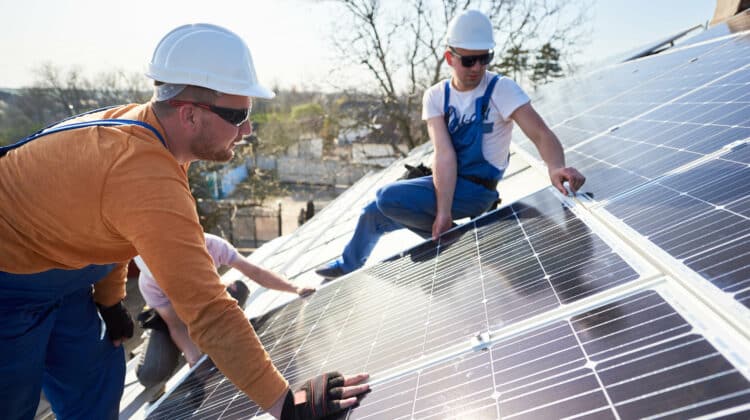 Male engineers installing solar photovoltaic panel system