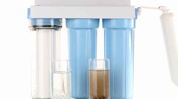 Filter system for water treatment with glasses of clean and dirty water  isolated on white