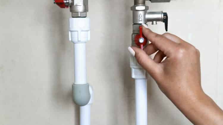 Woman's hand closes the valve Saving Water Consumption Concept