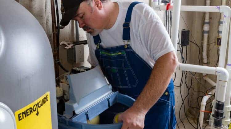 Workman replacing an old domestic water softener