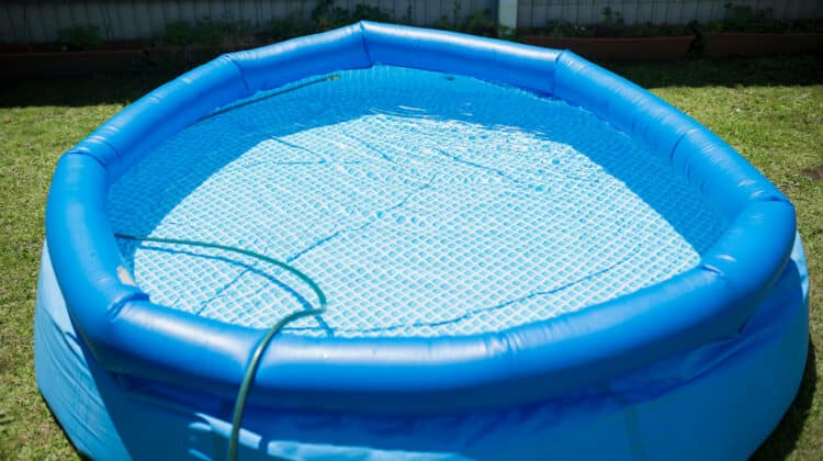 Small plastic swimming pool filled with water for outdoor recreation