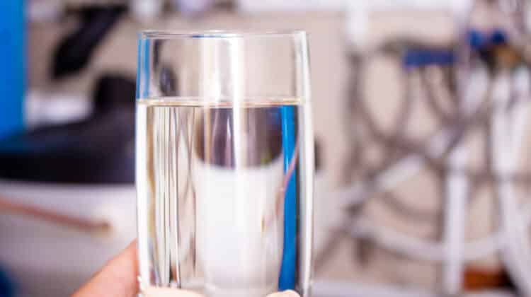 Clean water glass in hand Water softening
