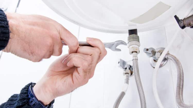 Plumber fixing electric water heater