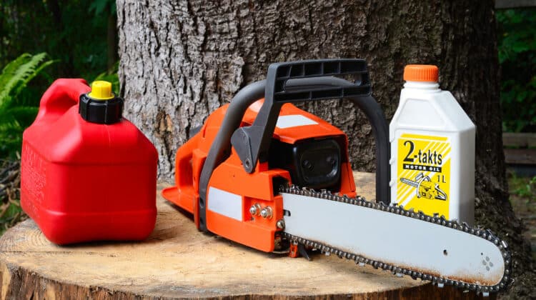 chainsaw and canister of gasoline and motor oil