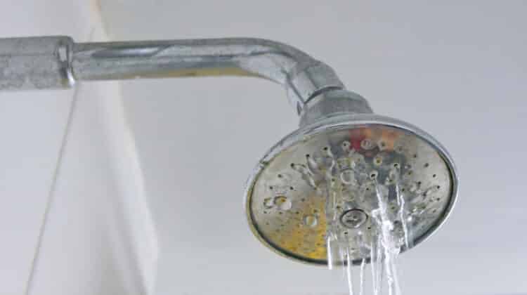 putting on clogged shower head after washing in bathroom partly causing annoying problems clogged water supply and accessory issues