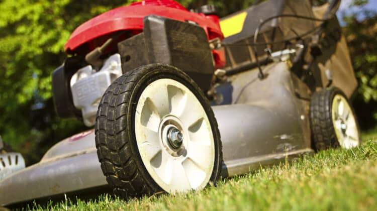 detail of classic Lawn Mower on green grass background