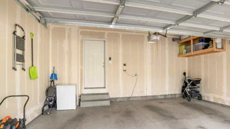 Garage interior with wall filler marks and white fire door