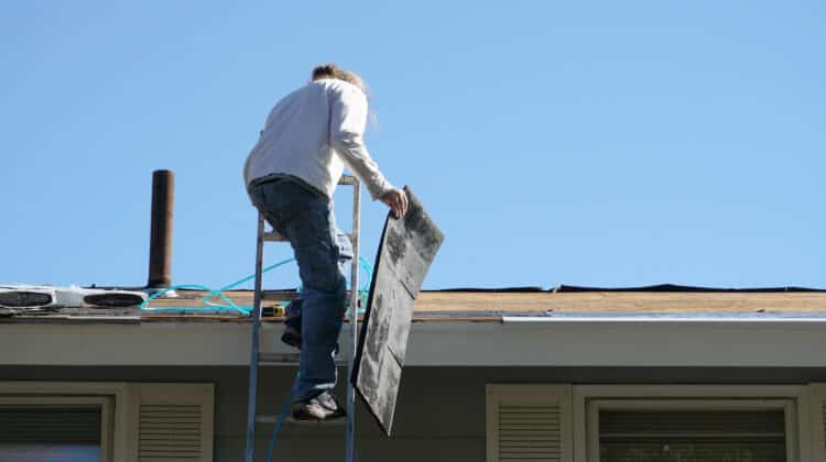 worker install new shingle on the roof