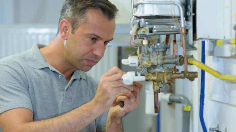 male engineer repairing a gas boiler